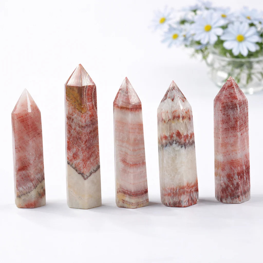 Dali jasper crystal tower point with natural red and cream banding on white background with soft shadow